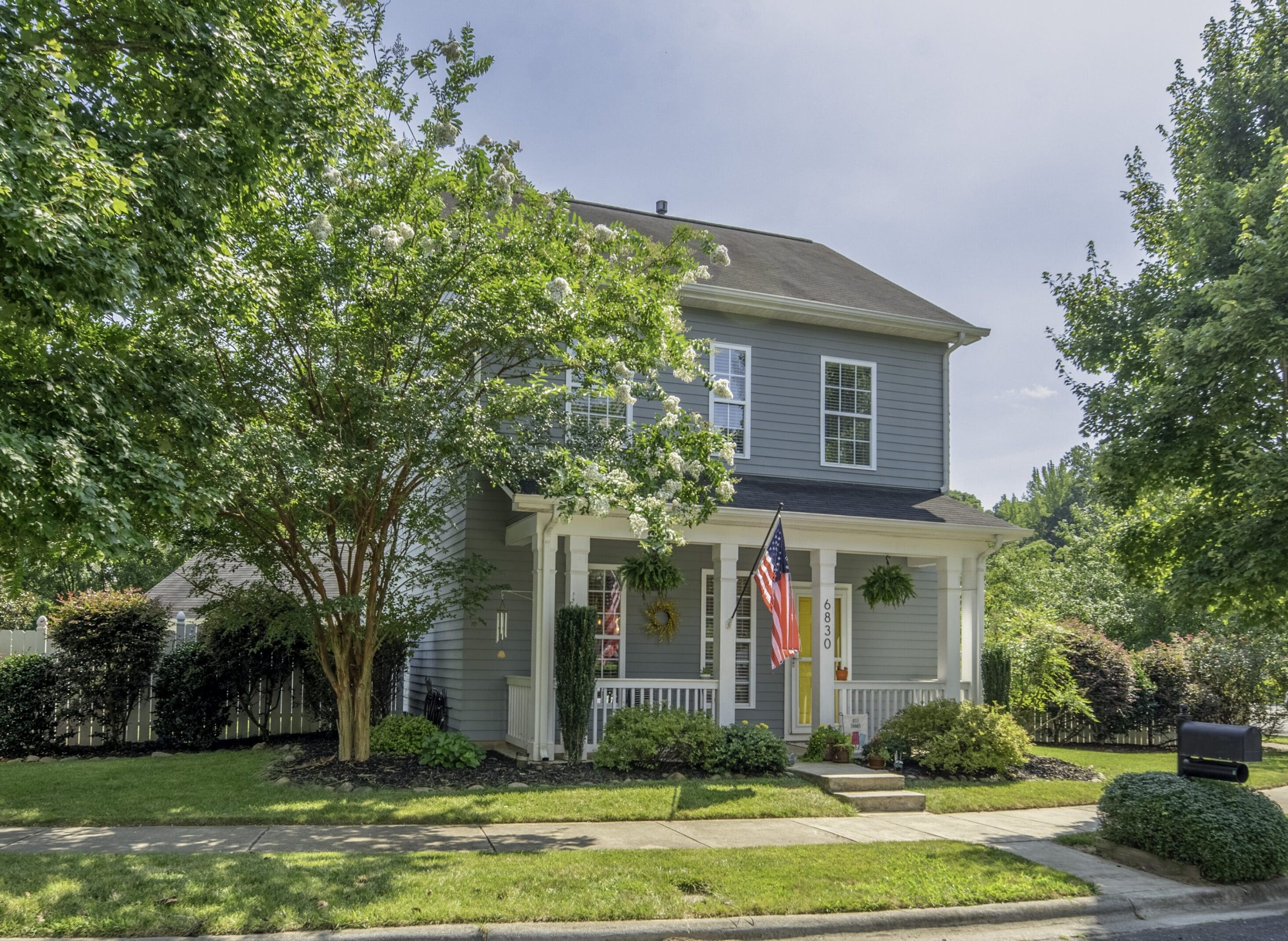 A house with trees and bushes in front of it