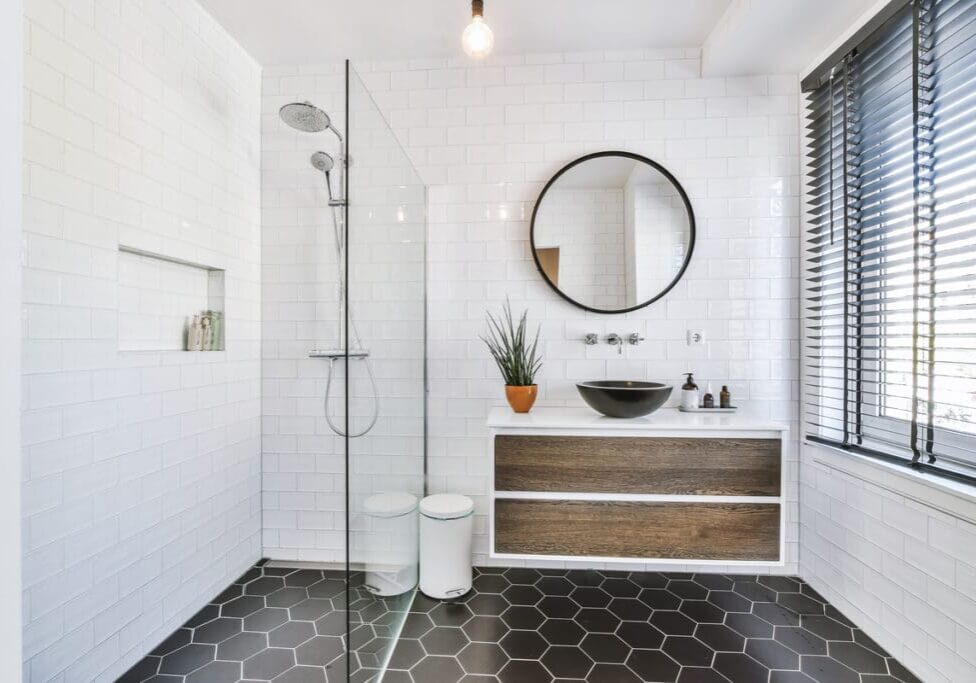 A bathroom with a shower, toilet and sink.